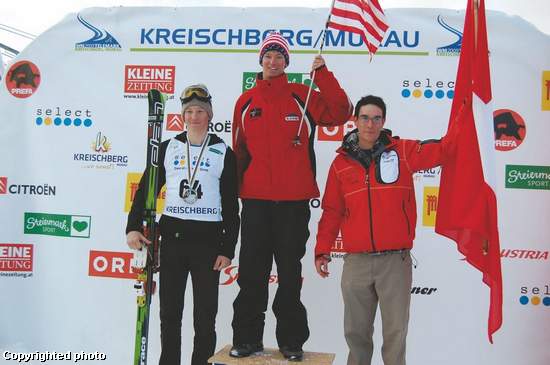Drew Hauser waves the American flag after being announced as the telemark junior world champion in Kreischberg, Austria, Jan. 24.